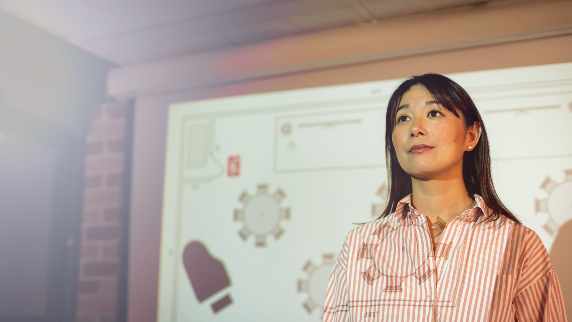 A female TAFE business student presenting her work in a classroom