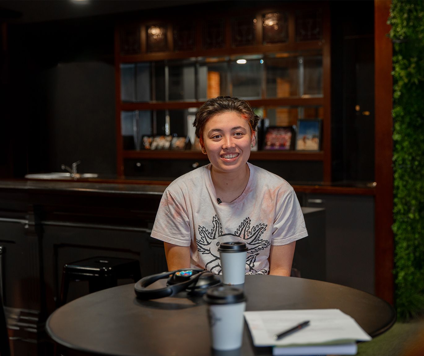 Arlo Fehring being interviewed at a café on Hawthorn campus Student of Swinburne University, sits at a café on a table across from the interviewee.