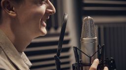 A Screen and Media student working on an audio recording project in a studio