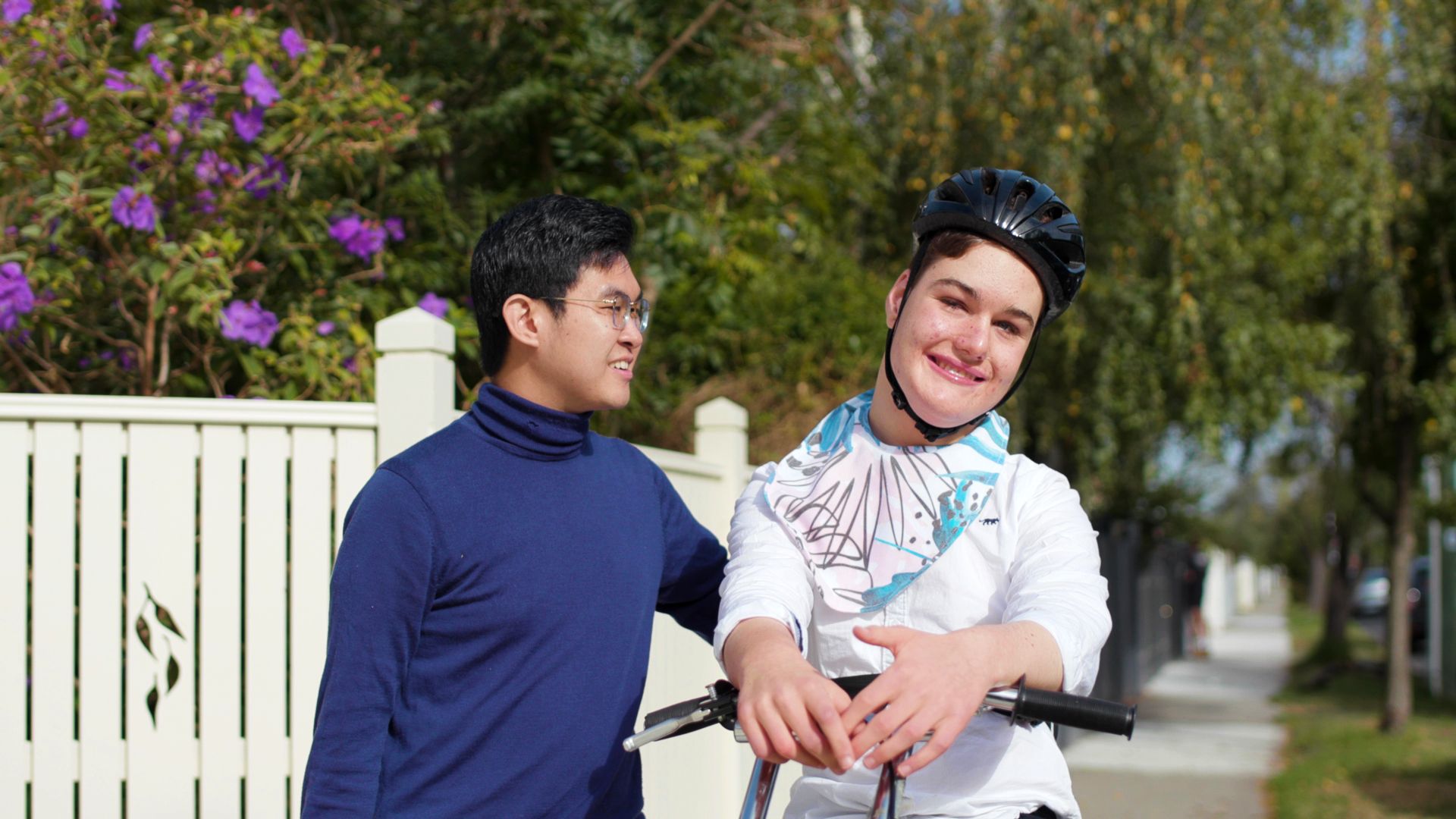 Hearth - Partner Story A placement student accompanying a disabled child on a walk outside a house