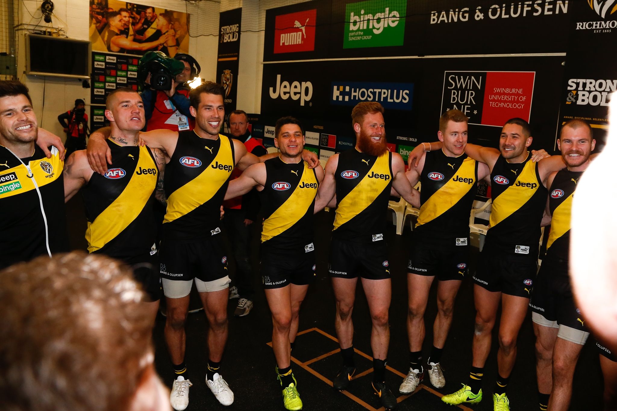 Swinburne partnership Richmond Football Club The Richmond Tigers AFL team stand in circle and sing club song in the wake of a victory