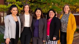 Five ladies in business attire from Avanade and Swinburne standing side by side