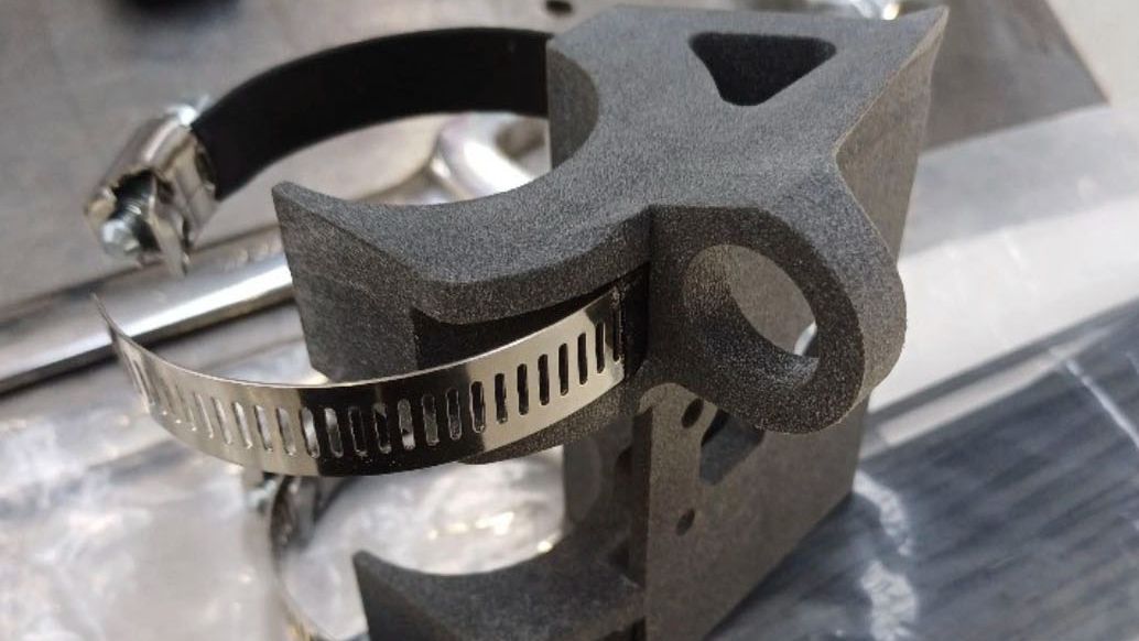 A component of a car created by Swinburne student, Tom Tom and a teammate attaching a steering wheel to Team Swinburne’s race car.