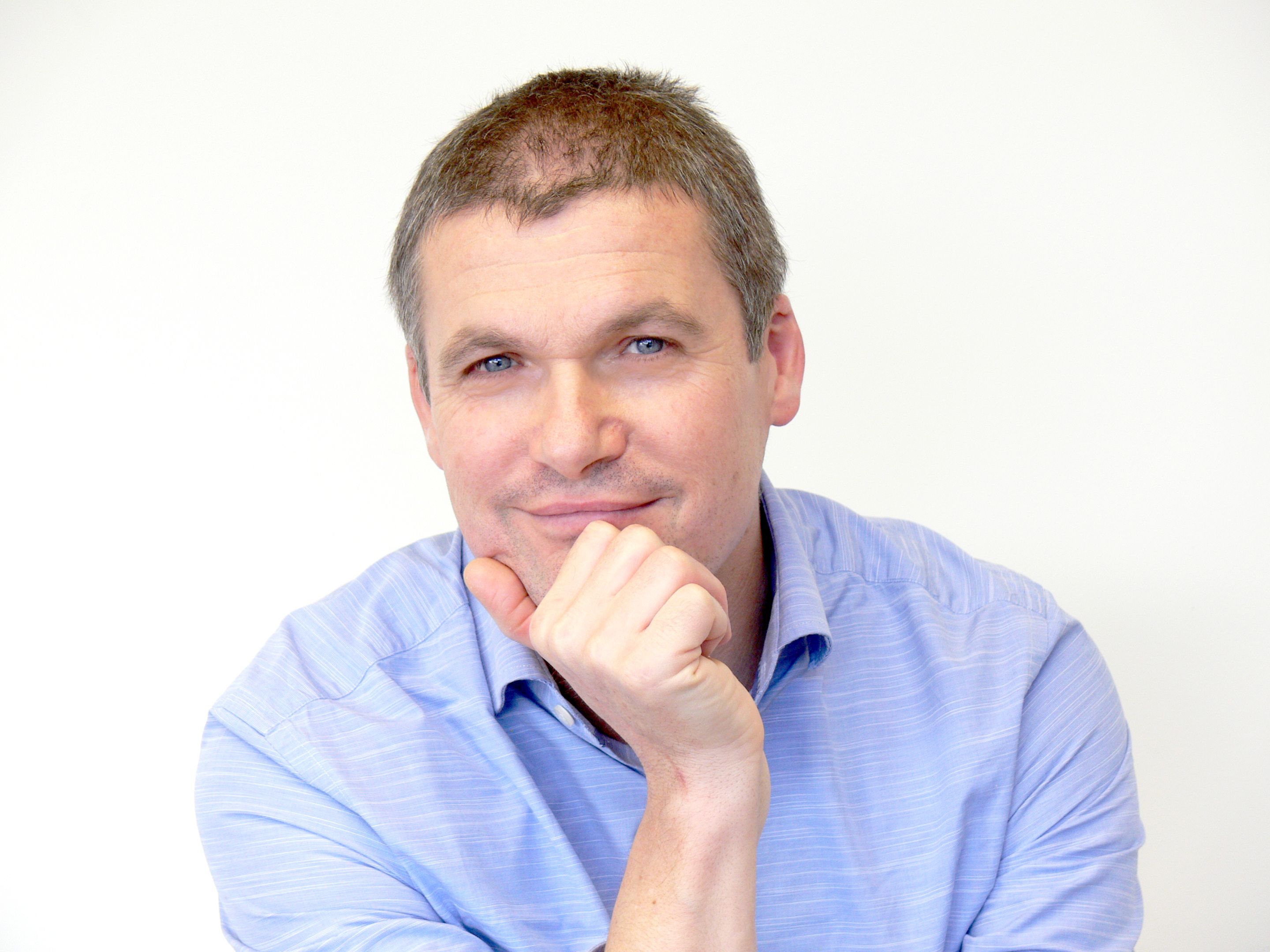 Steve Martinuzzo Cobalt Design Cobalt Design's Steve Martinuzzo sitting with his hand resting on his chin, wearing a blue collared shirt.