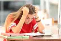 Frustrated student trying to understand notes in a bar