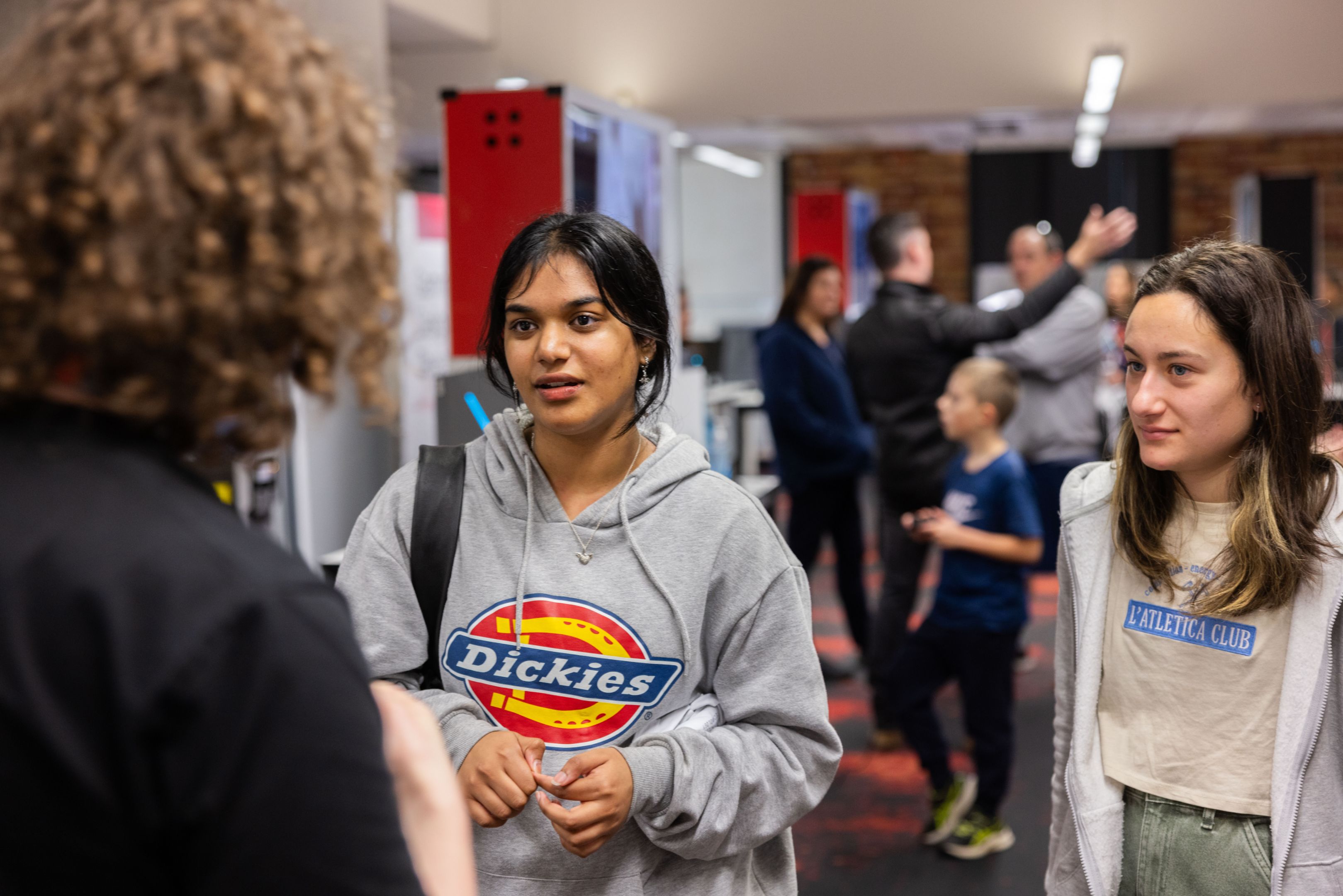 Swinburne Open Day 2023 Two high school students speaking to a staff member at Swinburne Open Day.