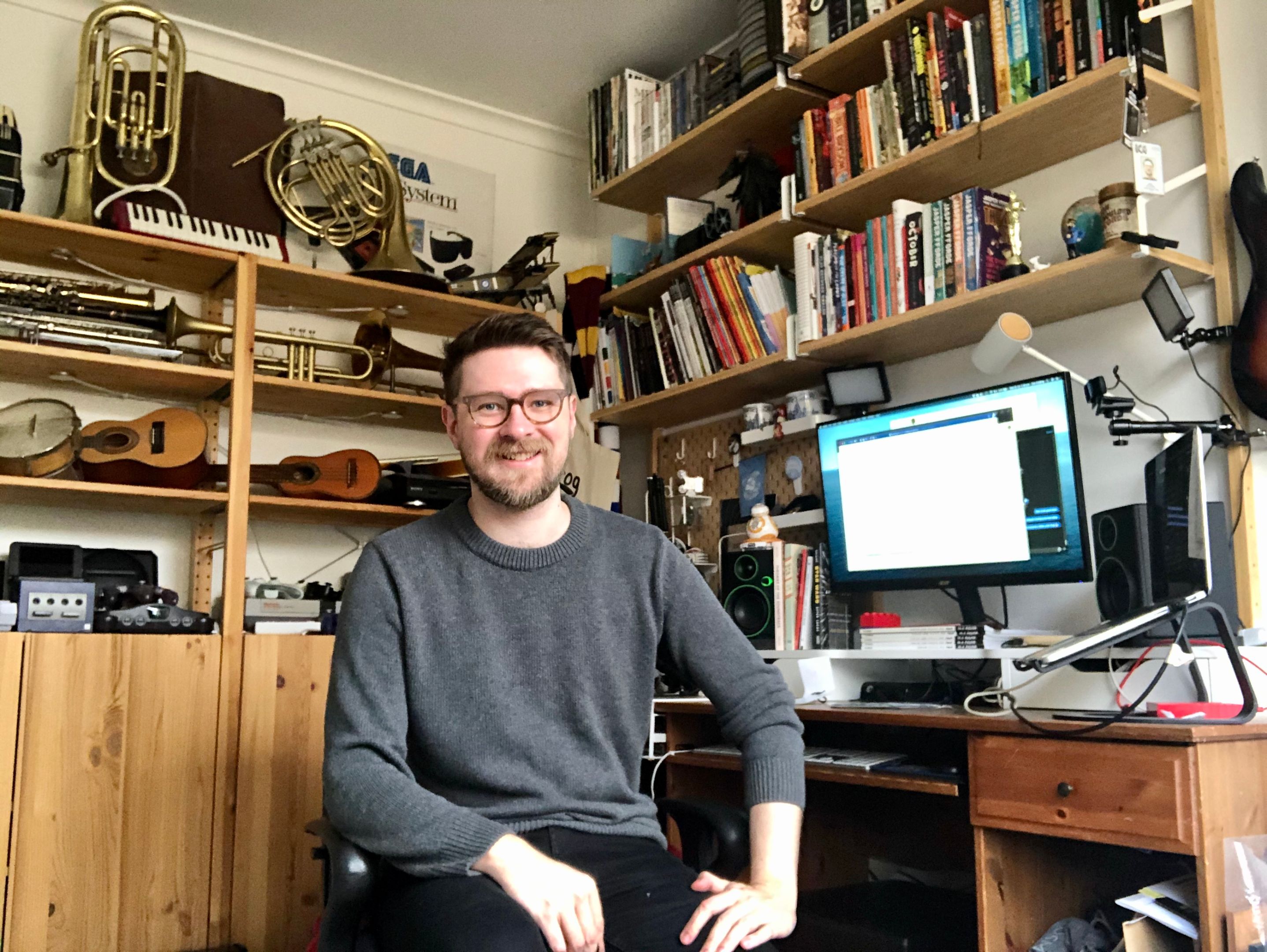 Dr Dan Golding in home office Dr Dan Golding in his home office surrounded by books and musical instruments.