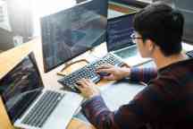 Pensive programmer working on on desktop pc programming code technologies or website design at office Software Development Company