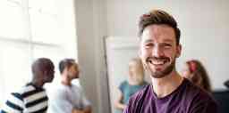 Smiling young designer standing in an office after a presentation