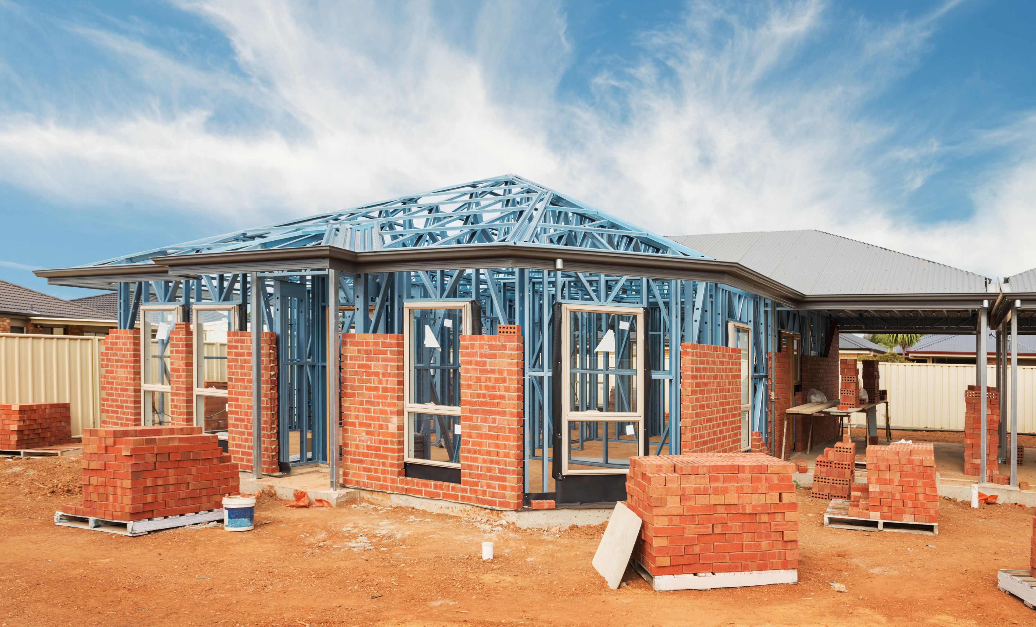 New home construction framing New residential construction home from brick with metal framing against a blue sky