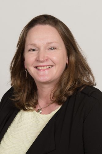Professor Susan McVie OBE Headshot of Susan McVie wearing a yellow top and black blazer