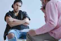 A withdrawn rebel young boy with behavioral and social disorders during his individual meeting with a psychotherapist.