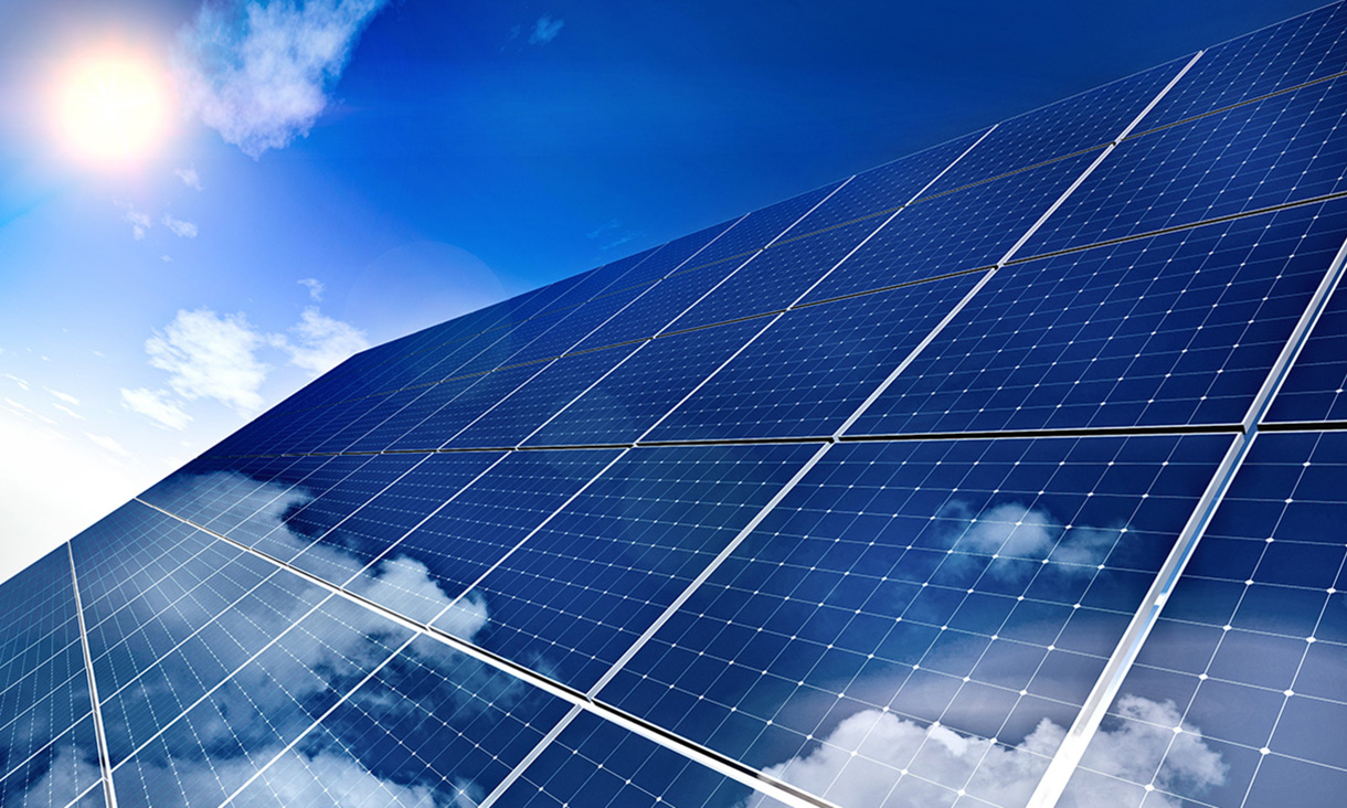 sun shining on solar panels