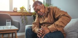 Man holding his knee in pain 