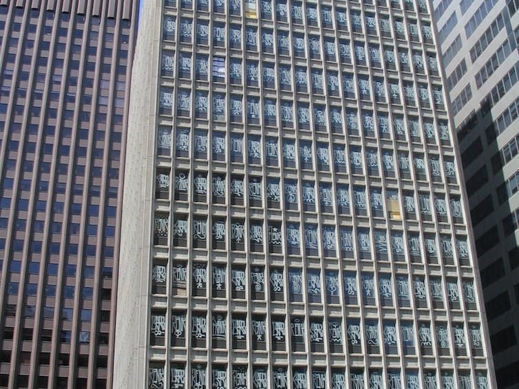A building with tagging on every window An empty office building in Melbourne with tagging on every single window.