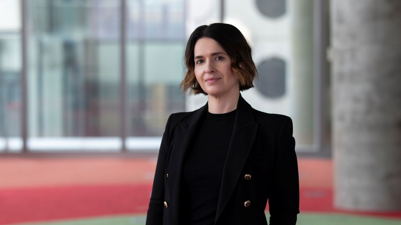 Lady with short brown hair in black suit in AMDC Building
