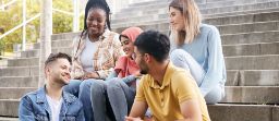 happy young people in university or college bonding in social conversation