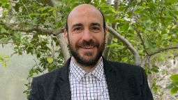Professor Federico Frascoli headshot smiling outside in front of a small tree