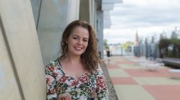Woman standing outside smiling for camera 