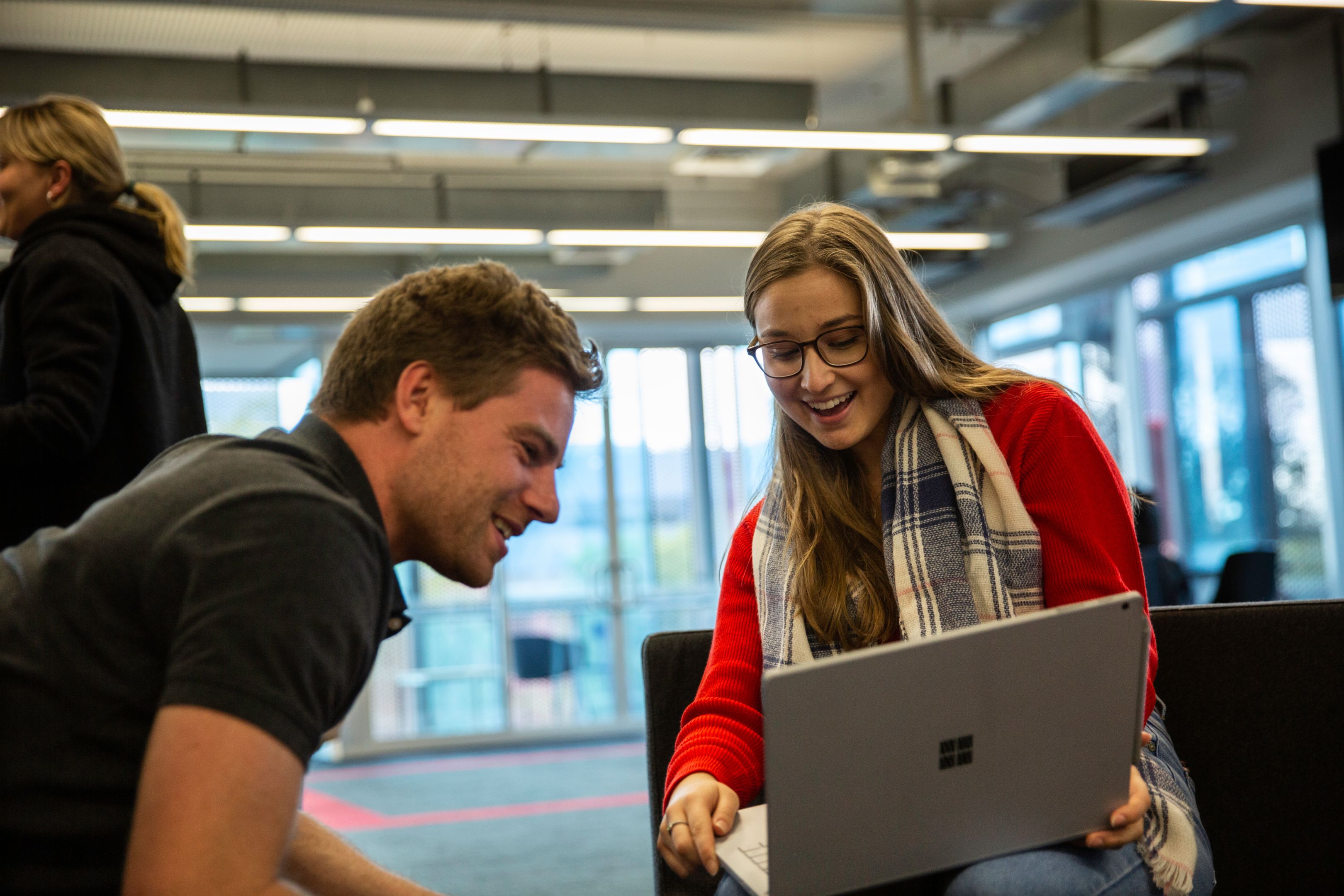 Student Ambassador 2019 One male and one female student look at the work they've done on a laptop