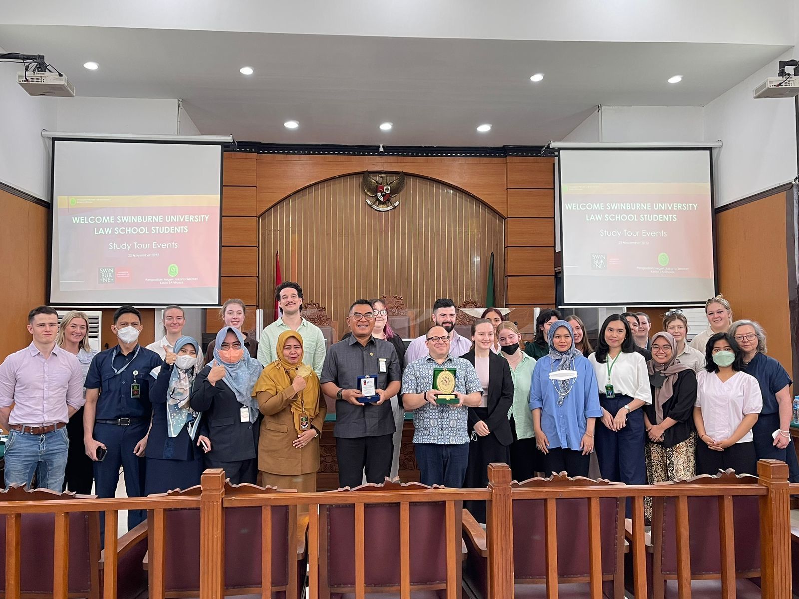 Indonesia Law, Governance and Culture study tour A group of students and staff stand in an Indonesian court room