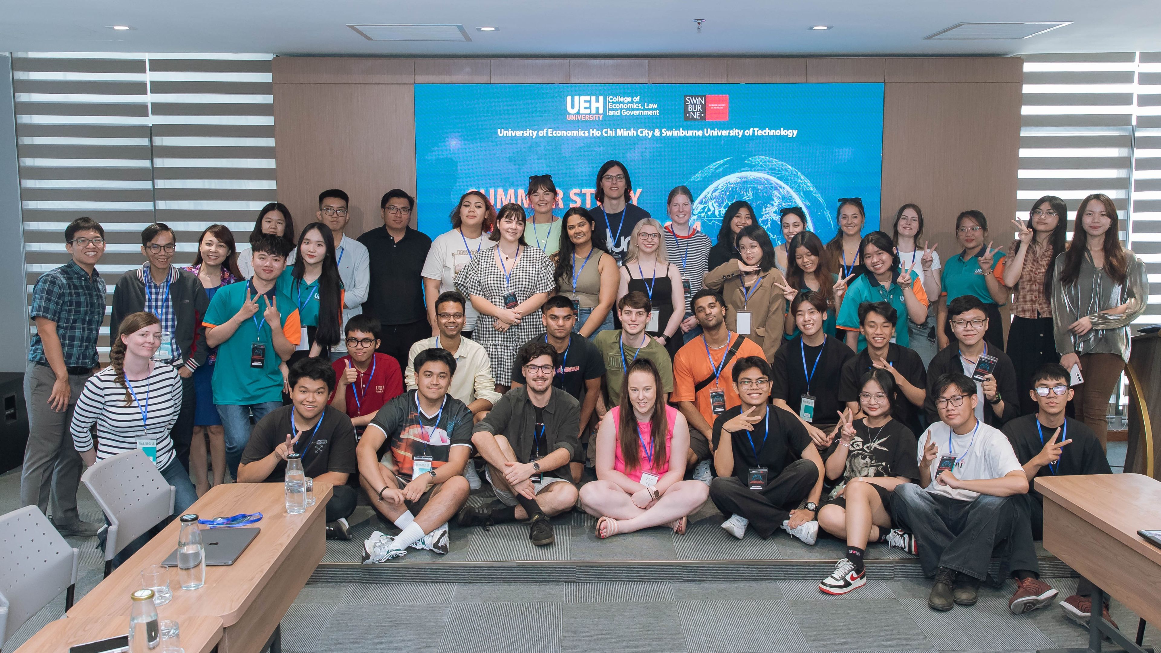 Vietnam Law, Governance and Culture Tour: UEH introduction day A large group of students and staff stand pose for a photo in an UEH classroom