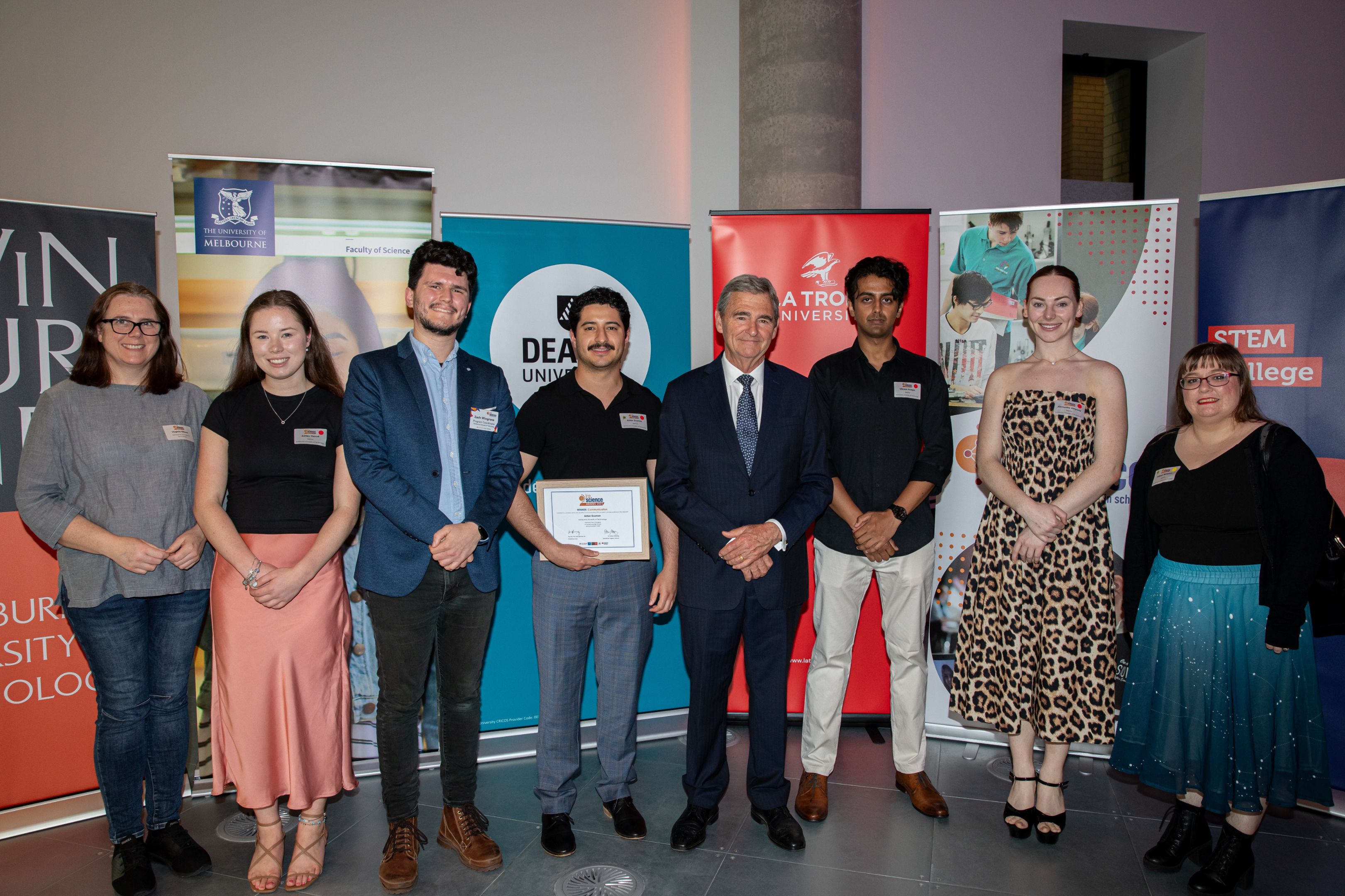 Swinburne In2science team The Swinburne In2science team stand with the Hon John Brumby AO in front of various university branding