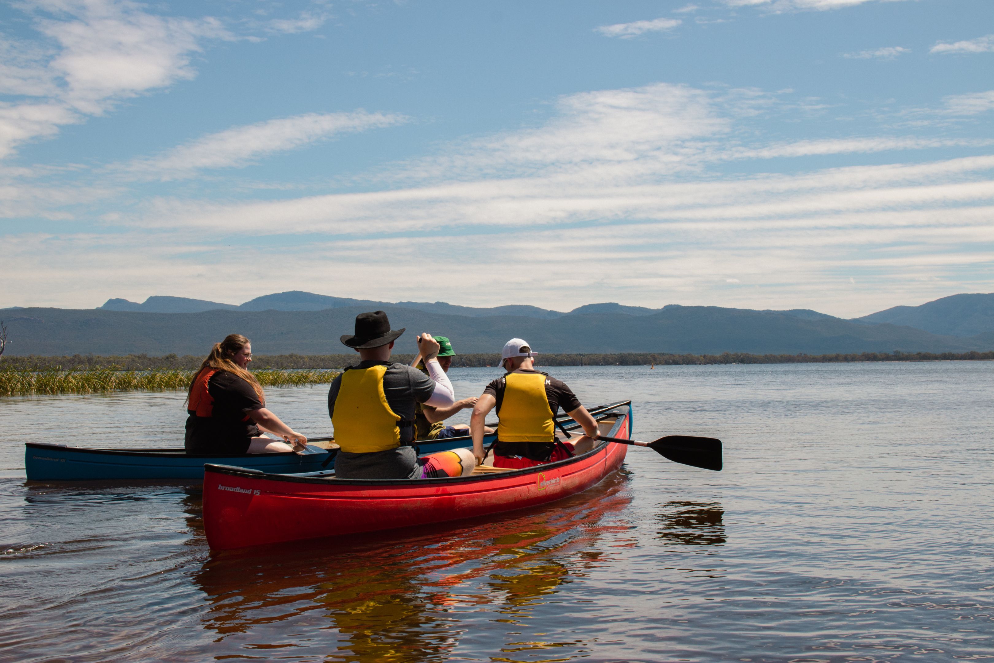 Participants of the MTC On-Country Development Program canoeing on a lake. Participants of the MTC On-Country Development Program canoeing on a lake.