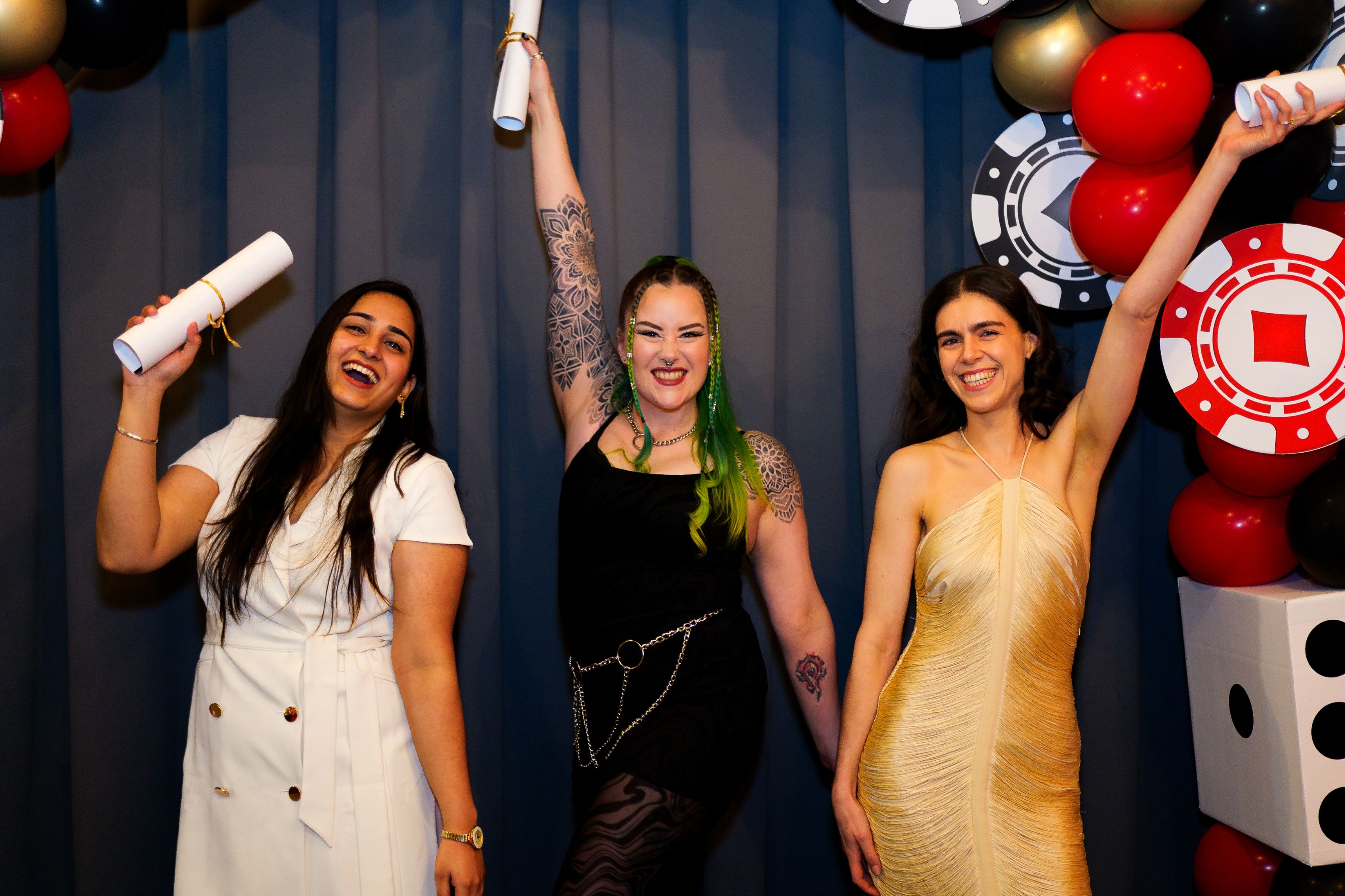 2025 SSA Volunteer of the Year award winners Mili Chawla, Cinder Stirling and Sinead Turton (left to right) posing with one hand up and smiling.