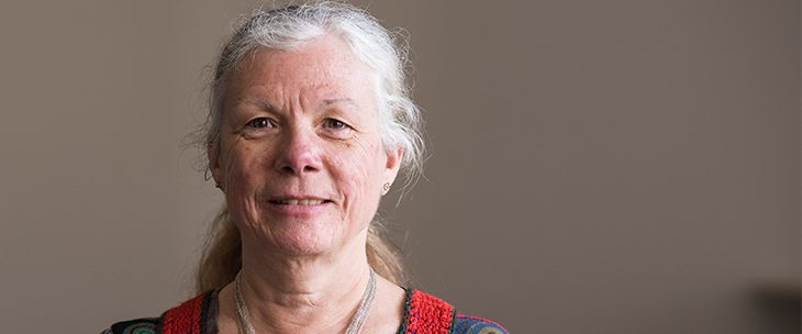 Sue Massey Older female with grey hair looking at the camera
