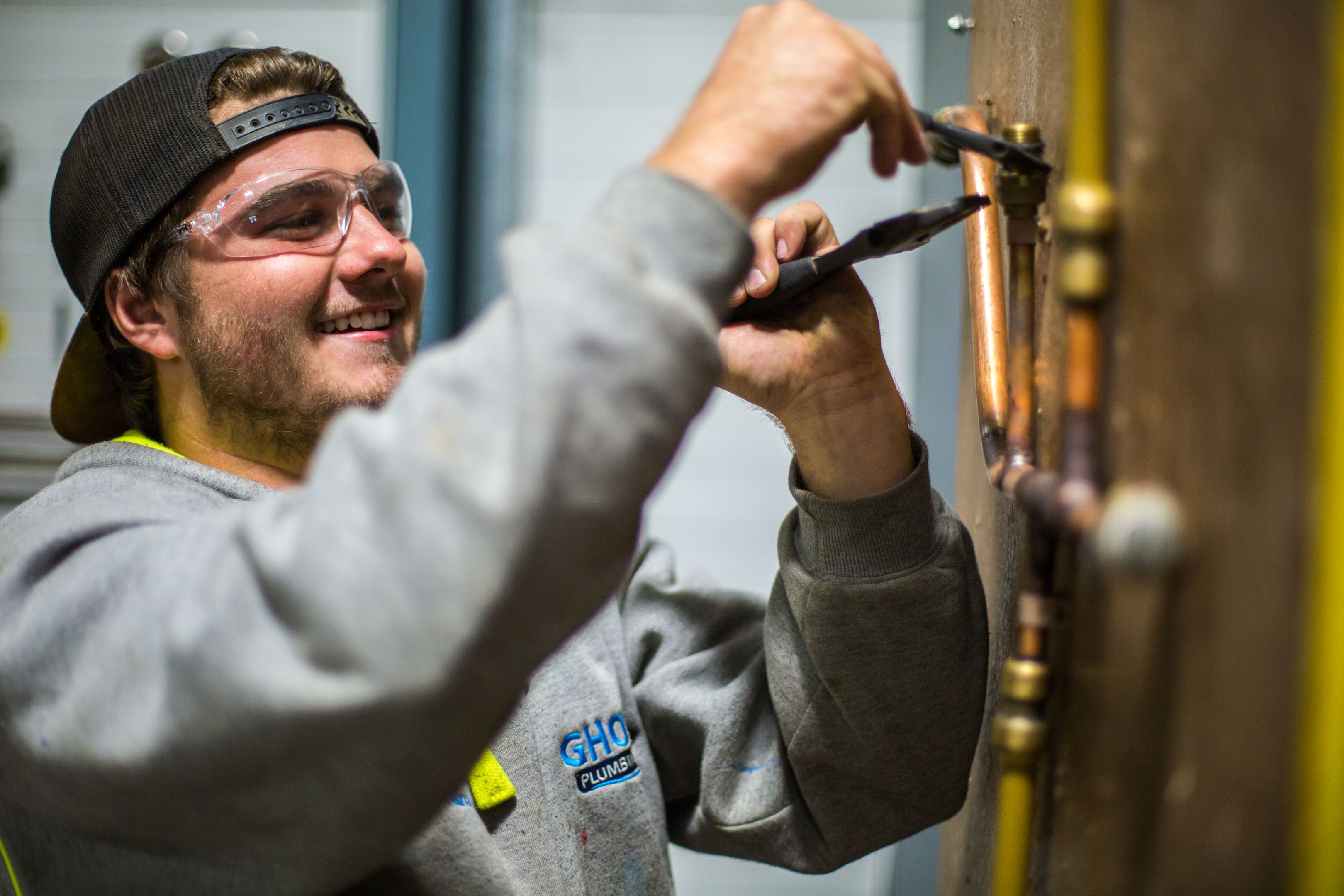 PAVE Plumbing Apprentice plumber working on a pipe chain at the Croydon campus