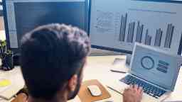 Male doing analysing statistics depicted on pie charts and graphs