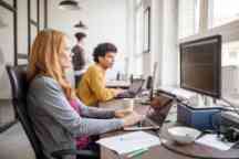 Female software programmer working with computers