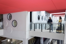 two students standing talking on walkway